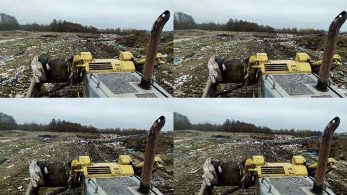 一辆垃圾填埋车将垃圾场的第一层垃圾整平。股票视频