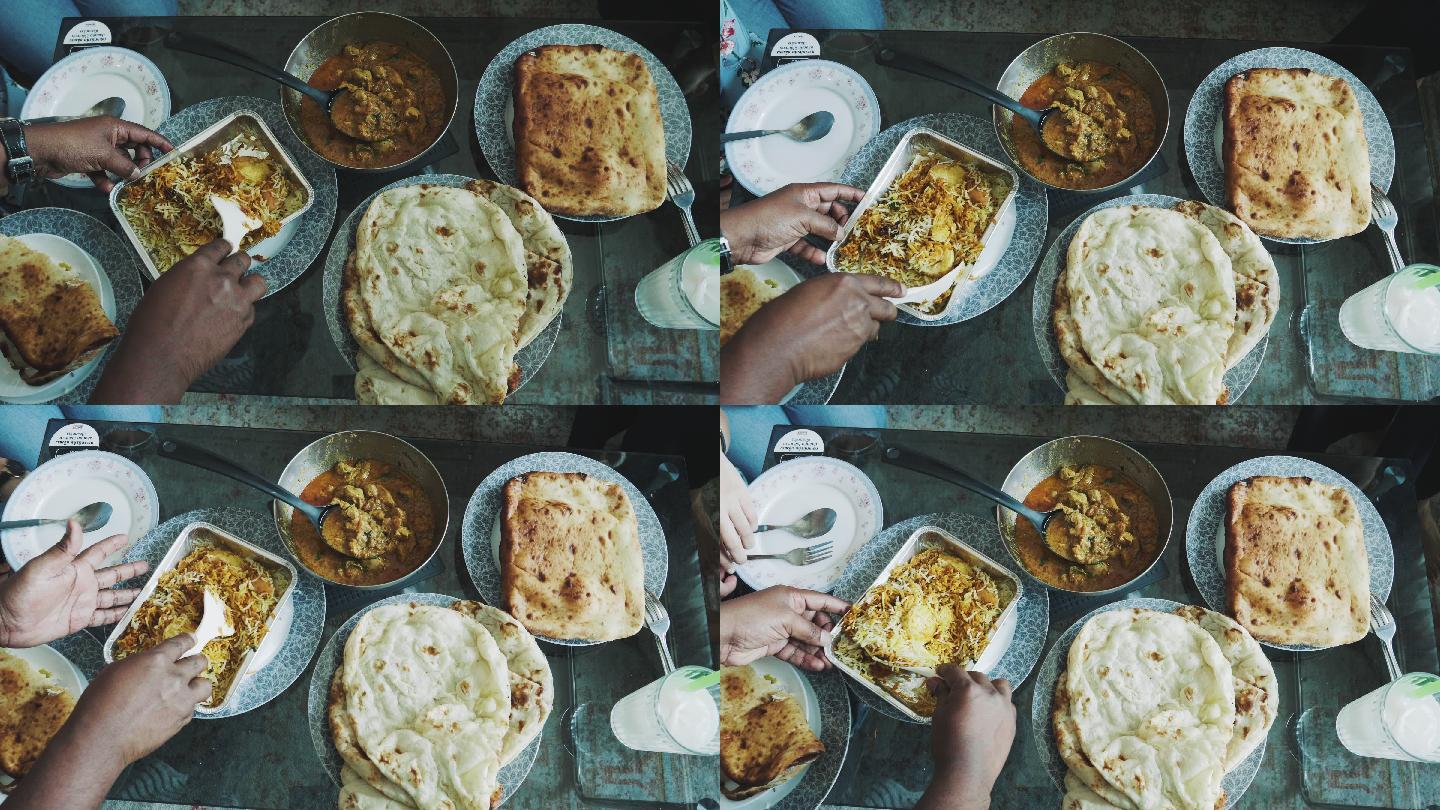餐桌上提供的人和各种印度食物的俯视图-库存视频