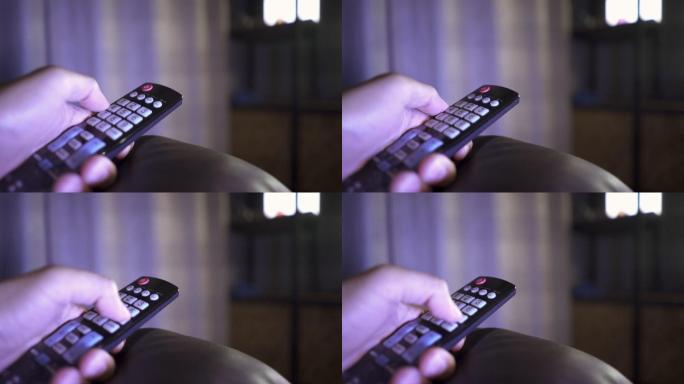 男子换手频道特写遥控器