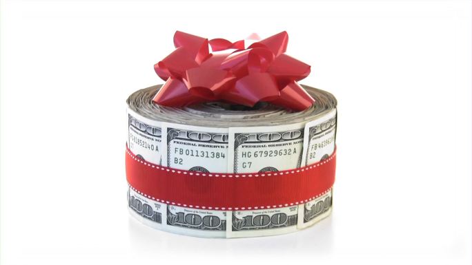一捆带弓的现金。金钱、金融、礼物、礼物的概念。