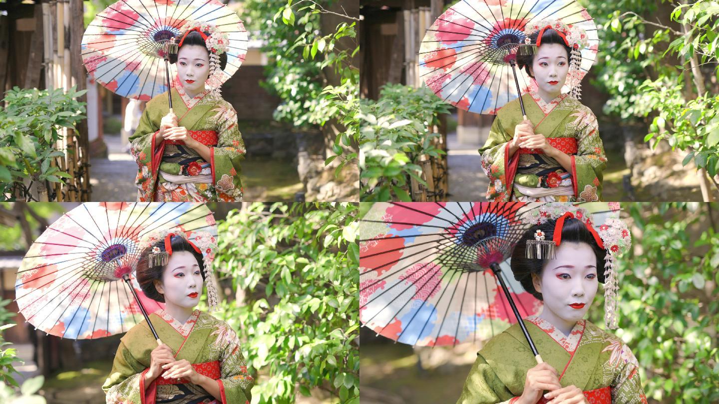 Maiko（艺妓在训练）在京都Gion的狭窄人行道上行走