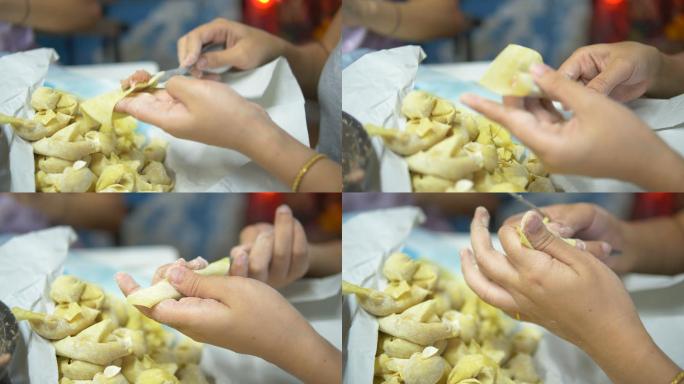 亚洲女性手工制作馄饨和饺子馅。