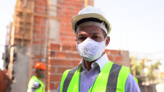 在施工现场使用防护面罩的工程师或建筑师肖像
