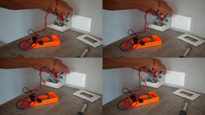 无法辨认的电工用万用表测量电源插座电压的特写镜头