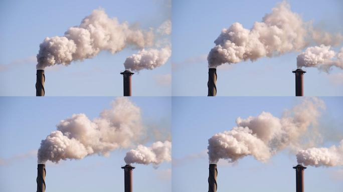 工厂午后阳光下的烟囱造成的空气污染。