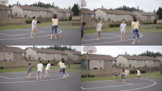 一群小学生在公园户外玩篮球游戏