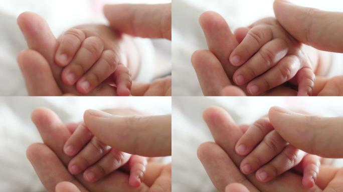 爸爸抚摸婴儿的手抚摸婴儿的手