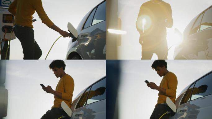 SLO MO年轻人在等待汽车充电时使用智能手机