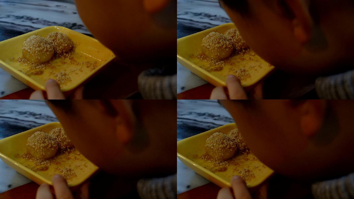 男孩在室内吃广东甜点