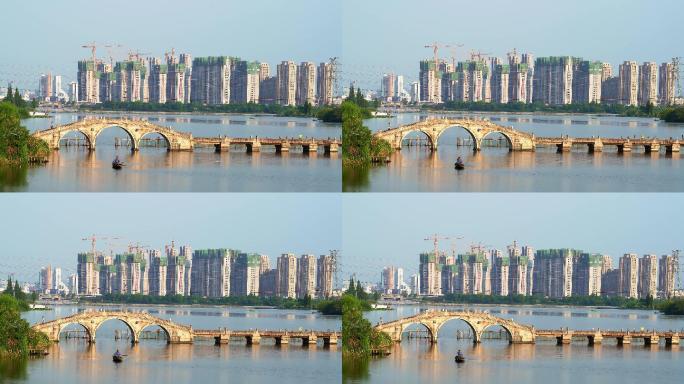 绍兴青甸湖古老石拱桥和远处的建筑工地