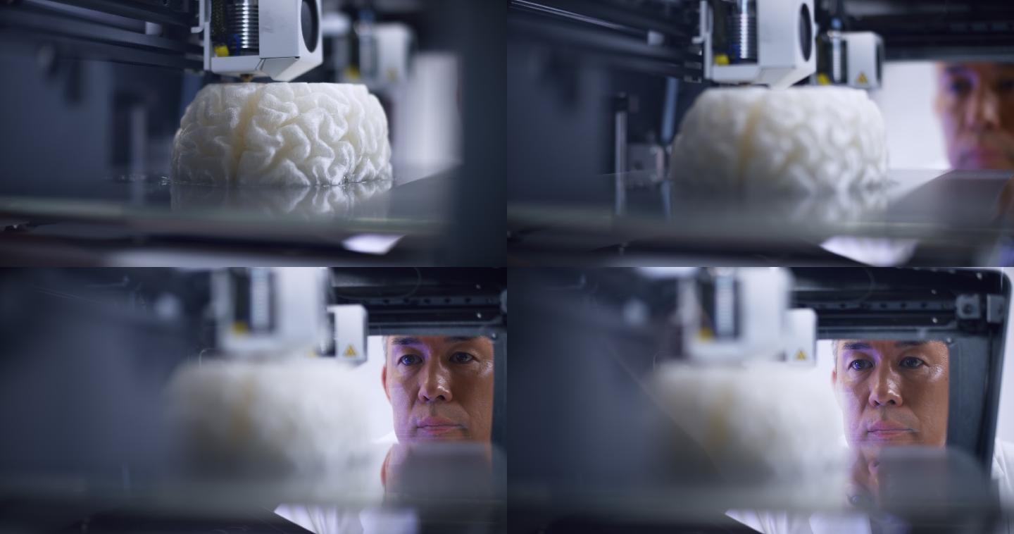 亚洲男性生物医学工程师在3D打印机中俯瞰大脑模型的构建
