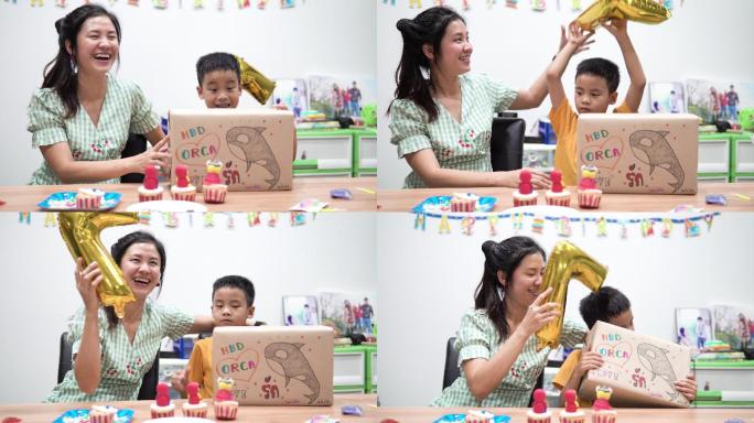 快乐的小男孩和妈妈打开礼品盒。