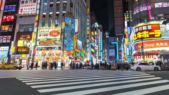 4K延时：晚上，日本东京哥斯拉路新宿区的购物街上，右转车流和人群步行
