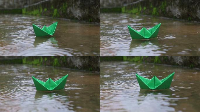 彩纸船浮于水面绿色小船蒙蒙细雨自然景色