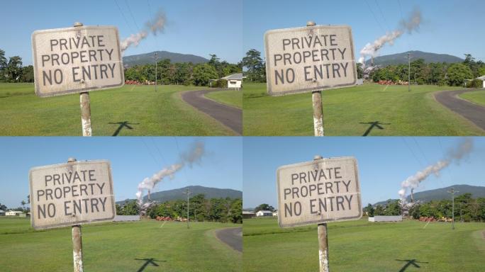 昆士兰北部热带地区一家糖厂烟囱造成的空气污染旁的私人财产标志