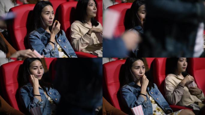 亚裔中国女性与朋友在电影院大厅里吃爆米花，等待电影放映时间，被过路的夫妇分心