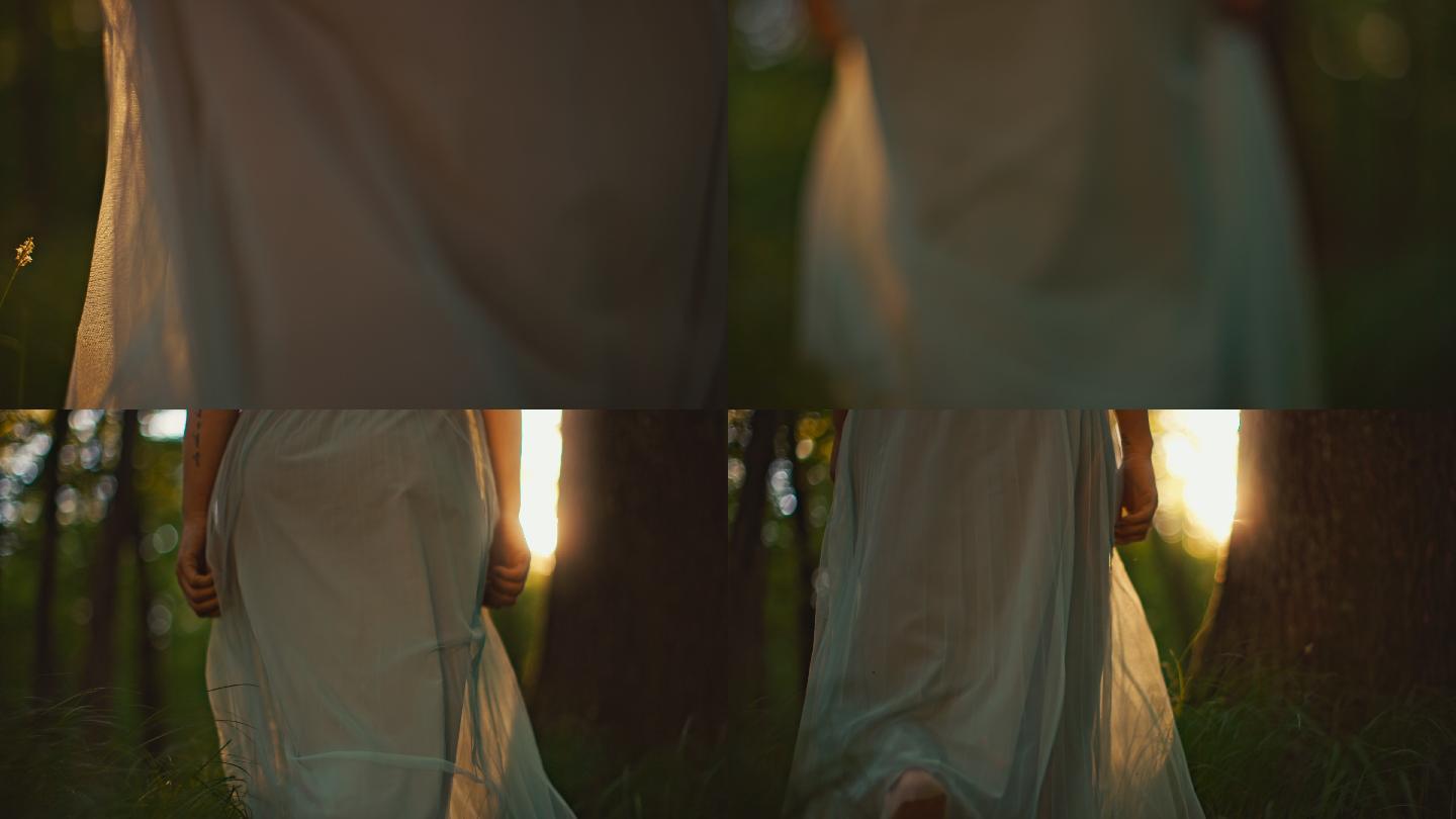 一个穿着白色长裙、面目全非的女人在森林里走向太阳，一边抚摸着树木
