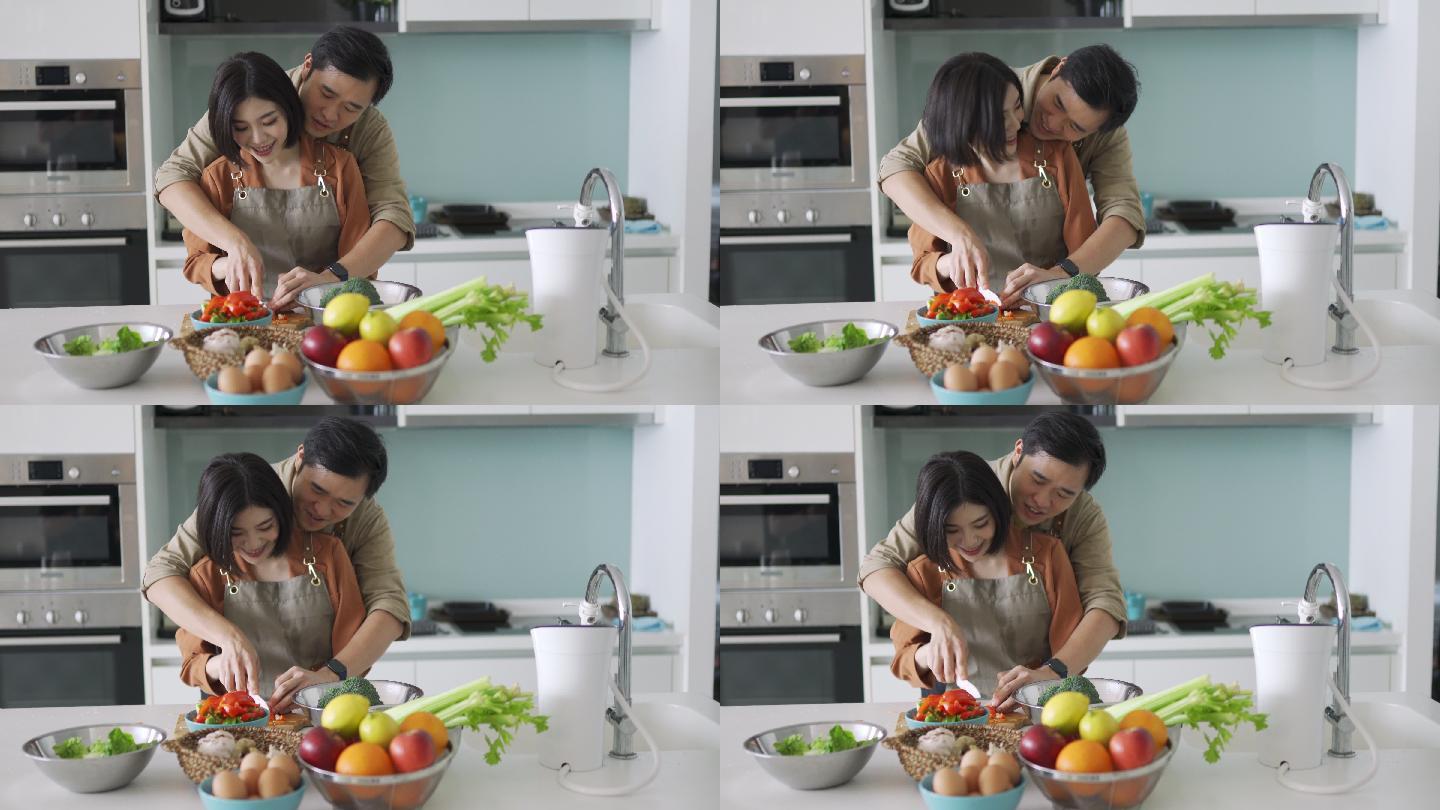 亚洲华人丈夫教妻子在厨房切菜