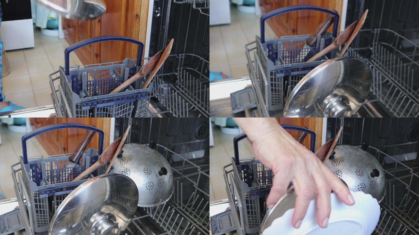 女人正在把脏盘子放进洗碗机里，双手特写