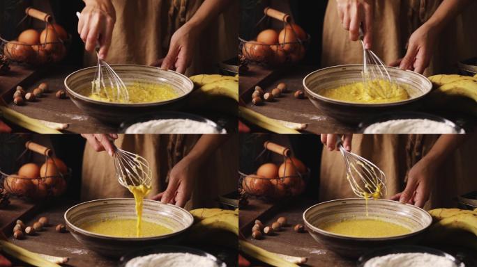 一个女人在碗里搅拌香蕉面包糊的特写镜头