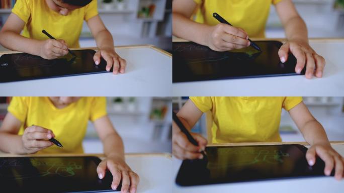 小男孩在图形平板电脑上画画