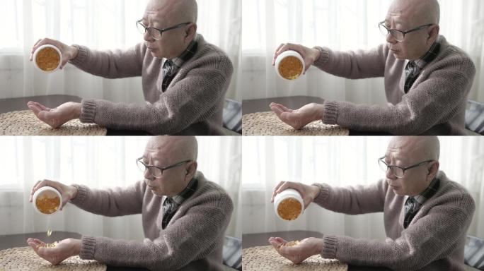 一位上了年纪的中国男子手里拿着一瓶药，倒出胶囊，慢动作射击