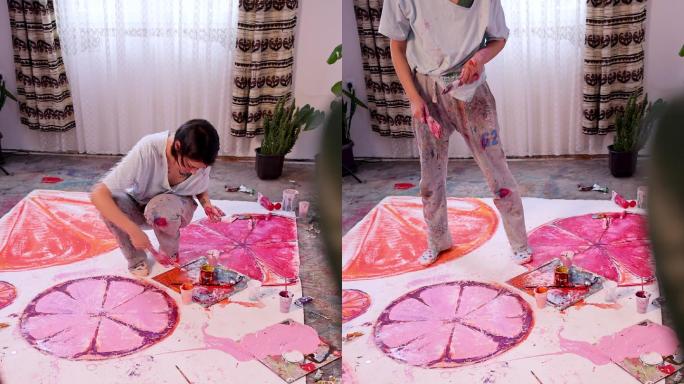 高加索女画家用玫瑰色颜料在画布上绘画