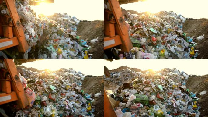 垃圾填埋场上的垃圾车正在倾倒垃圾。垃圾运输车