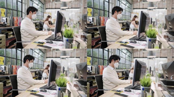 现代办公室新常态工作环境2019冠状病毒疾病，亚洲商人通过屏幕分隔与客户和朋友打电话做生意，戴上防护