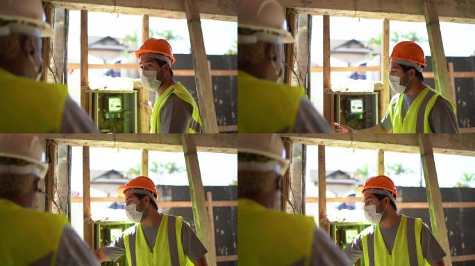 建筑工人在施工现场检查电力-戴防护面罩