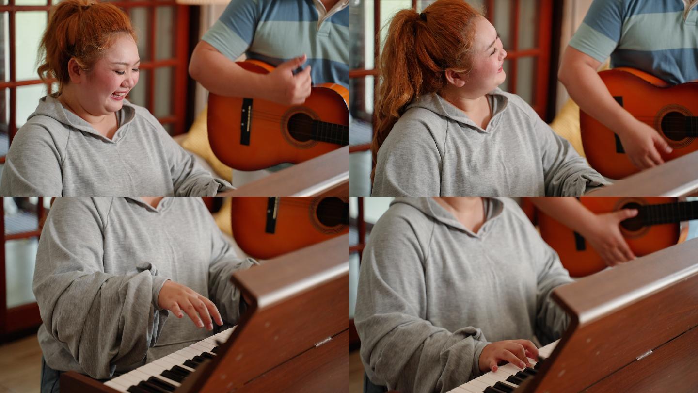 亚洲身材魁梧的年轻夫妇在家里一起弹钢琴和吉他