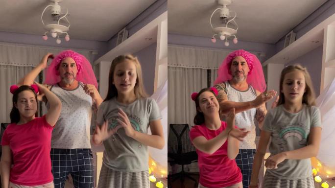 父亲和女儿在家里的卧室里为社交媒体跳舞-有特殊需要的女孩-手机摄像头视角