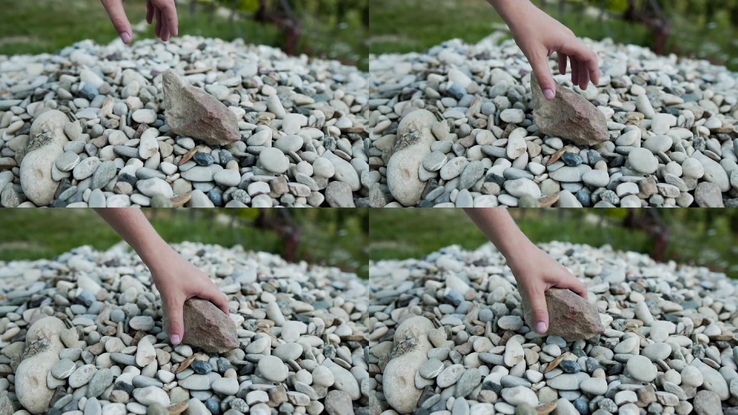 孩子用慢动作举起石头
