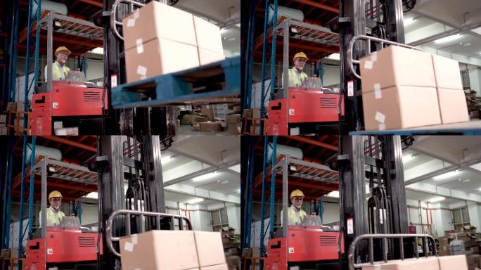 亚裔中国高级工人在工业工厂使用叉车搬运货物