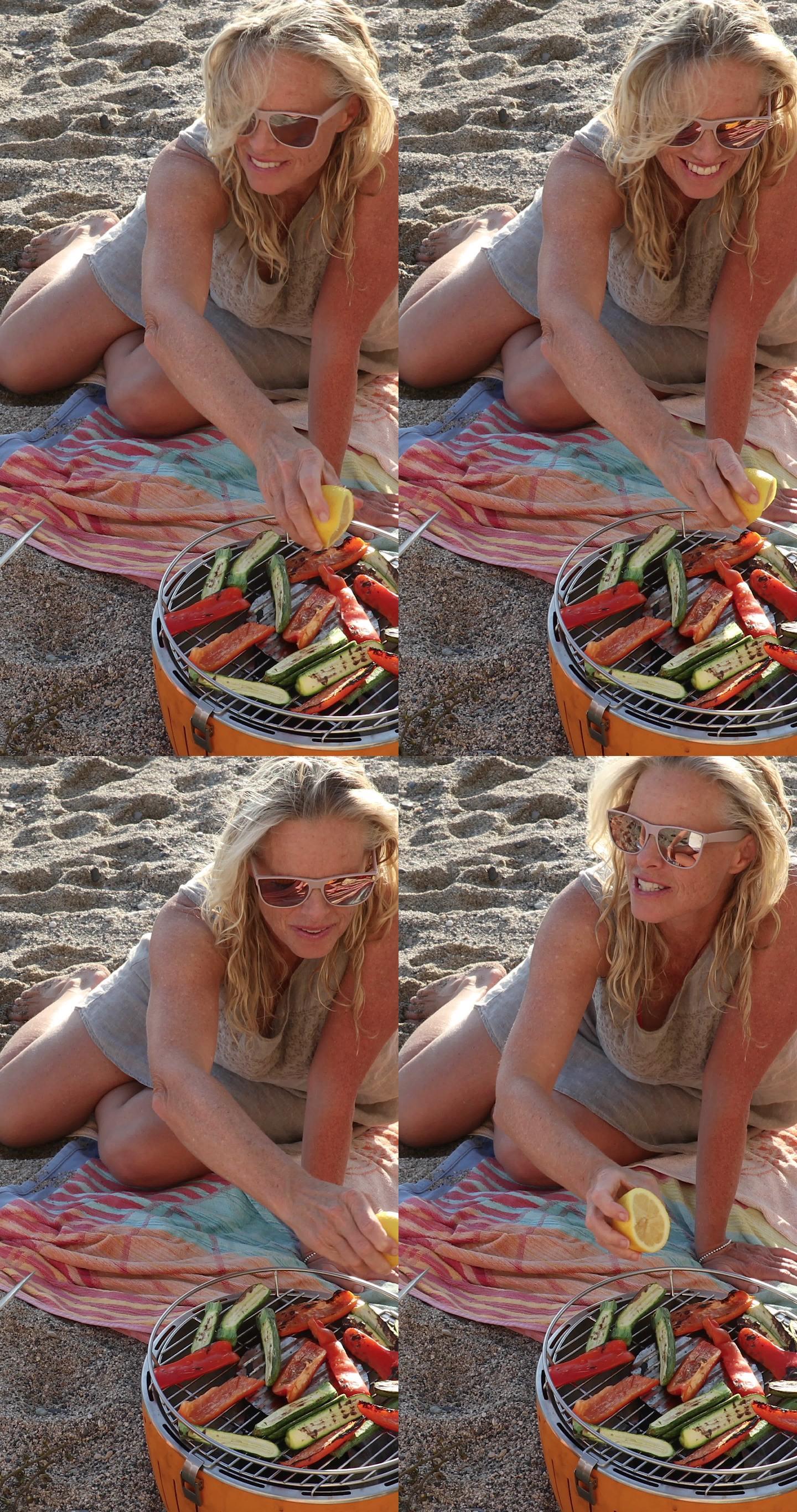 一位女士在海滩上准备烧烤蔬菜