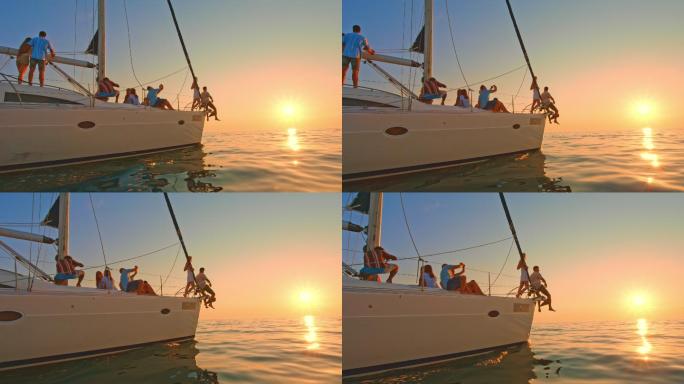 帆船上的人们在海上欣赏日落
