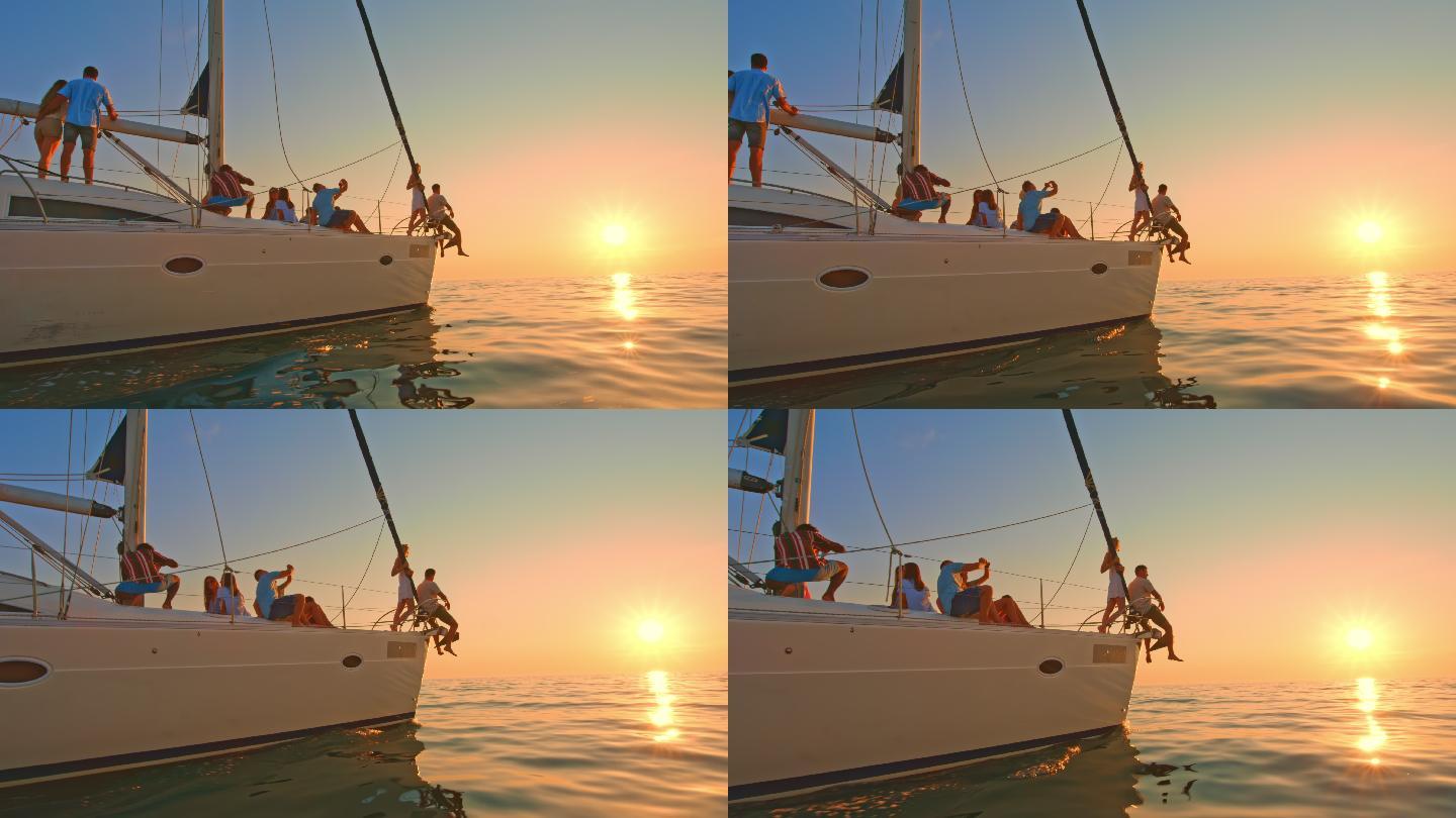 帆船上的人们在海上欣赏日落