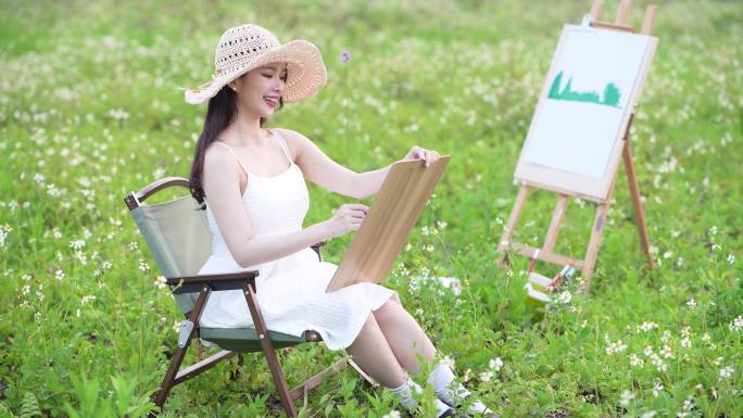 女孩在草原上画画