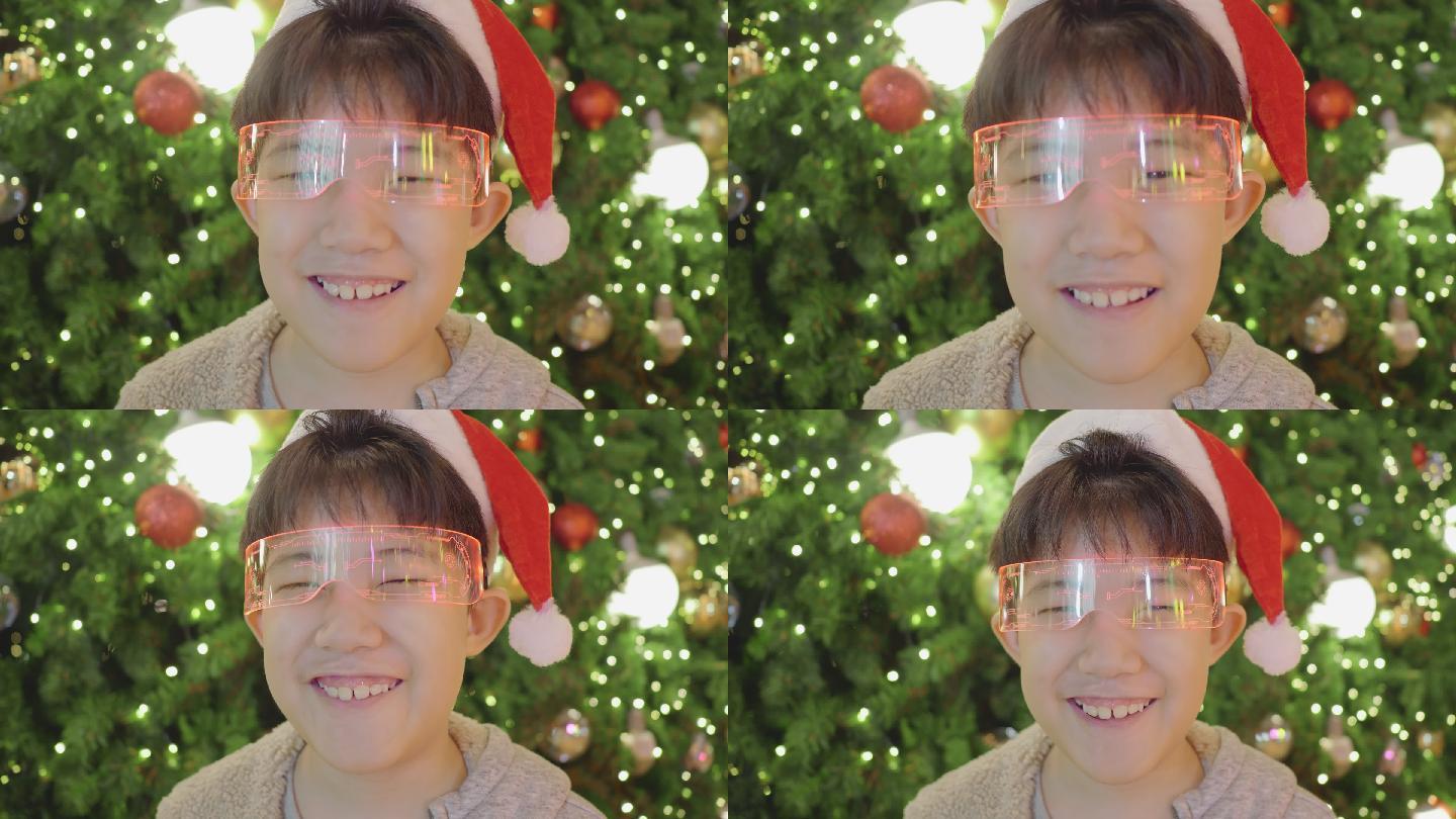 亚洲男孩看着相机在圣诞节快乐地微笑