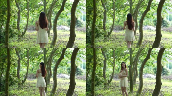 女孩在树林下轻松漫步