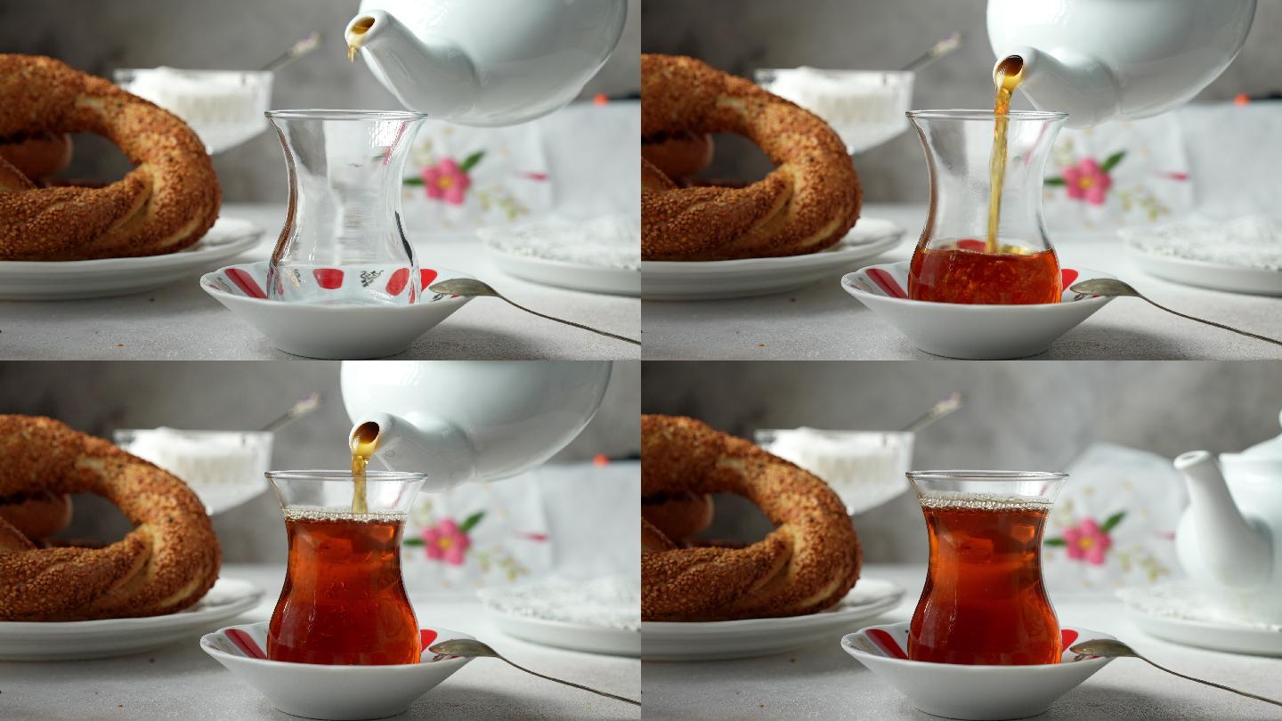 用瓷茶壶和土耳其百吉饼倒传统土耳其红茶