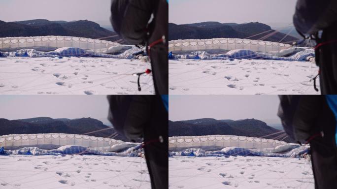 在阳光明媚的冬日进行滑翔伞飞行，鸟瞰图。极限运动和冒险越野飞行员。