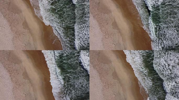 绿色波浪在干净的海滩上破碎-空中