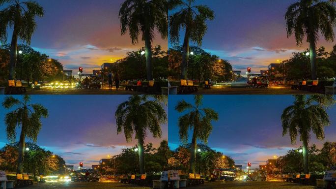 在老挝万象的日落时分，租用的三轮车在巴吞西等待乘客，背景为红绿灯。