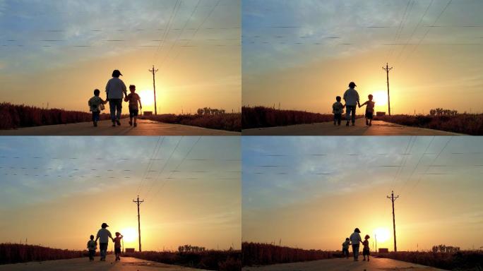 妈妈和孩子行走在夕阳下