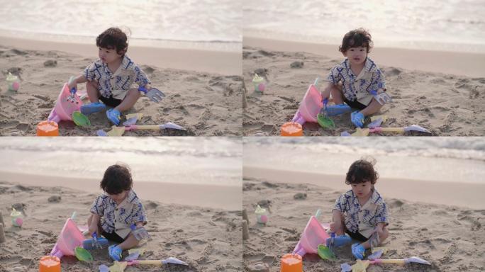 小男婴喜欢在海边玩沙子。