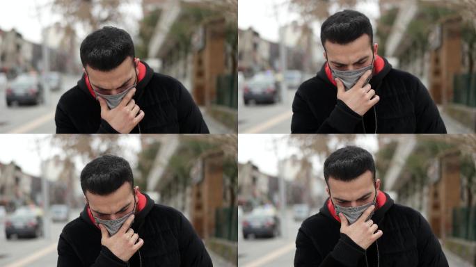 生病的年轻人戴着口罩，在户外咳嗽。