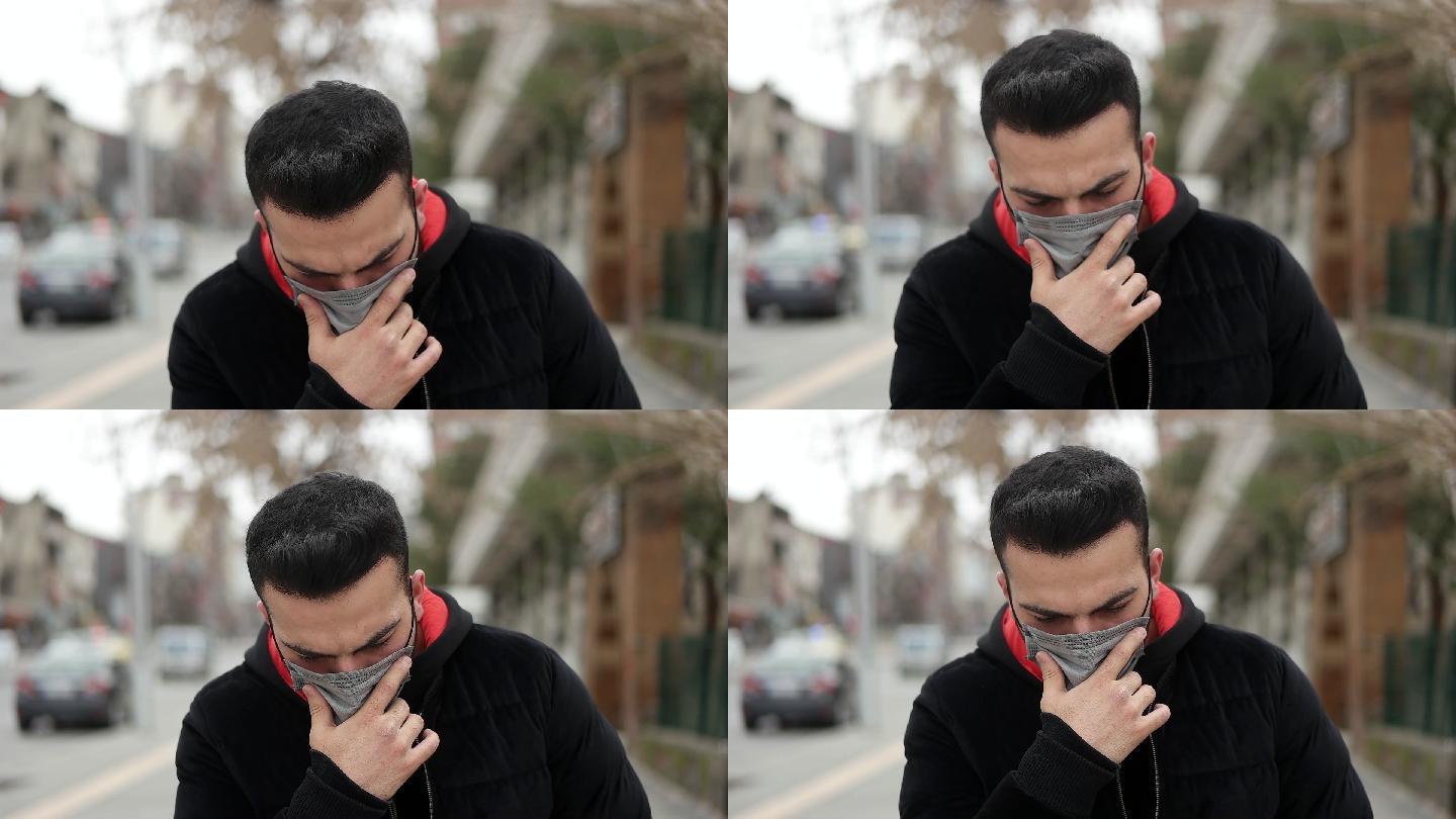 生病的年轻人戴着口罩，在户外咳嗽。