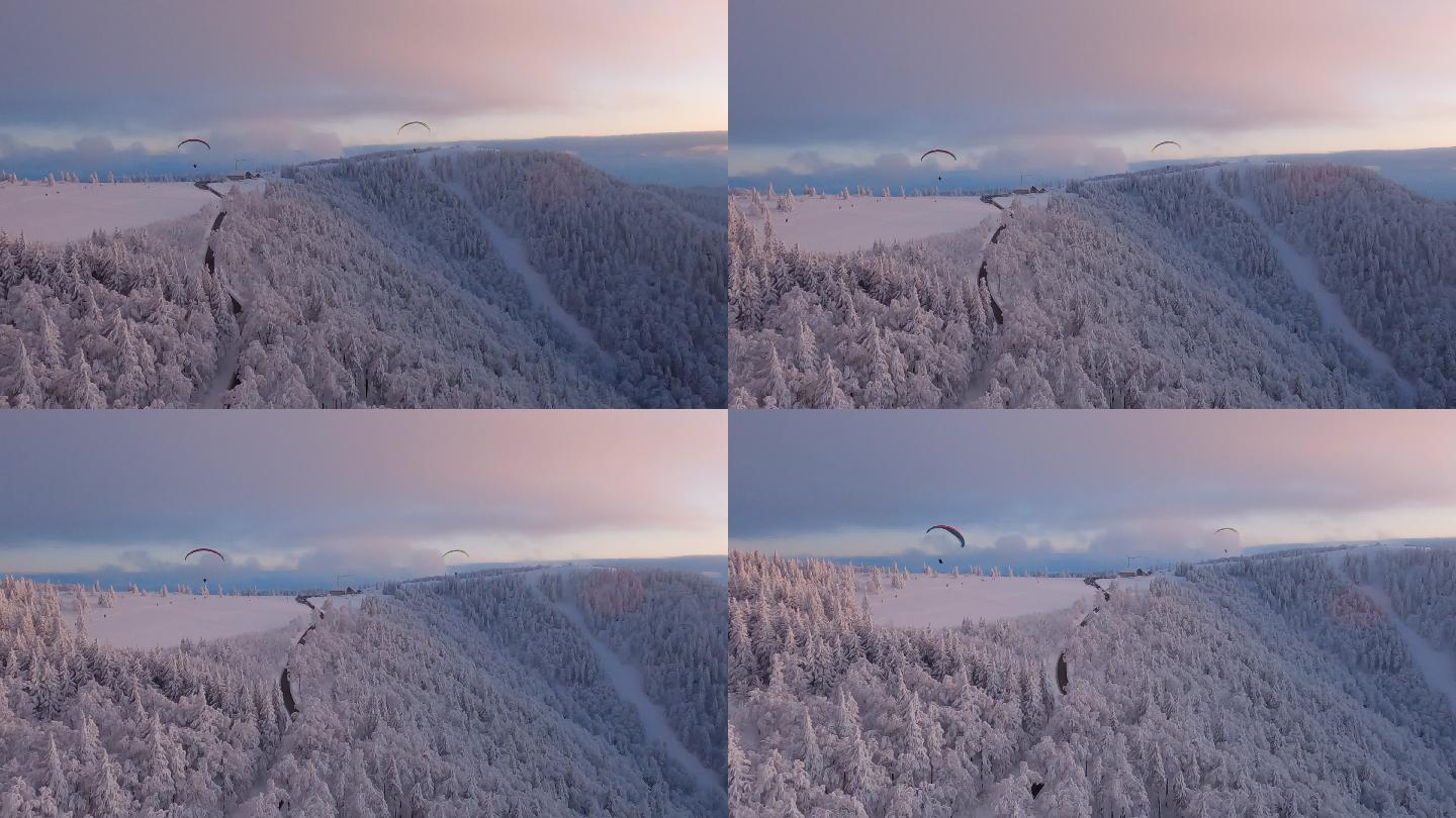 冬季日落时的山脉和滑翔伞鸟瞰图