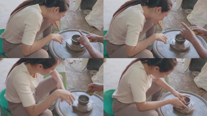 一位亚洲女性泥塑艺术家在她的工作室里用旋转的陶轮工作。可持续性生活方式